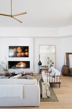 a living room filled with furniture and a fire place in the middle of the room