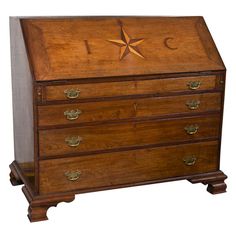 an old wooden chest with a star on the top and two drawers below it, against a white background