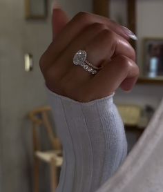 a close up of a person's hand with a ring on top of their finger