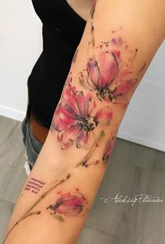 a woman's arm with pink flowers on it