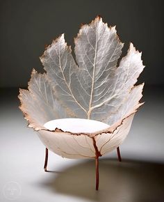 a leaf shaped bowl sitting on top of a table