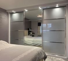 a bedroom with mirrored closet doors and a bed