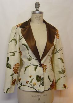 "Hand Made women's blazer with puffed sleeves, measurements are: Bust, 35; waist, 26; hip, 36; jacket length is 26\" long. Puff sleeve, 24\" long.  Hand made by the designer.  2 buttons in front, vintage bronze color metal buttons, one of a kind garment but I can make different sizes to order.  Lined inside without the sleeve. Dry clean only.  Outer fabric is linen cotton with machine embroidered flowers. Beautiful jacket. Lining is polysatin." Luxury Embroidered Long Sleeve Blazer, Luxury Women's Blazer With Floral Embroidery, Luxury Floral Embroidery Women's Blazer, Luxury Floral Print Blazer For Workwear, Luxury Festive Blazer With Floral Embroidery, Luxury Fitted Blazer With Resham Embroidery, Luxury Long Sleeve Embroidered Blazer, Luxury Floral Embroidered Blazer For Party, Luxury Floral Embroidery Festive Blazer