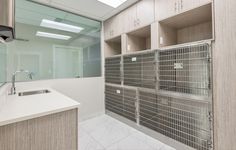 an empty bathroom with lots of cabinets and drawers on the wall next to the sink