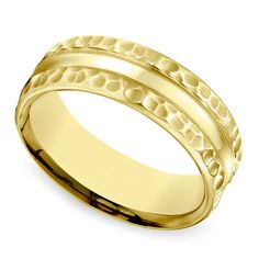 a yellow gold wedding ring with an intricate design