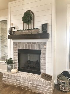 a fireplace with a sign above it that says welcome to the family and is decorated for fall