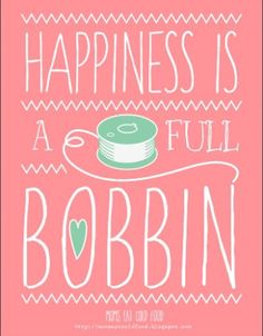 a pink poster with the words happiness is a full bobbin