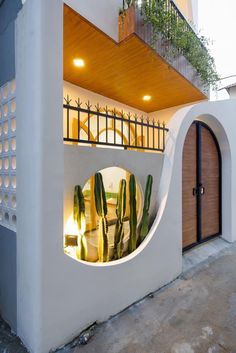 a house with a circular window and cactus in it