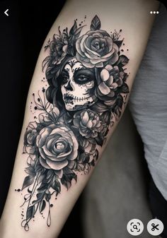 a woman's arm with a skull and roses on it