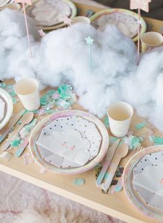 the table is set with pink and green plates