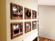 the wall is decorated with family photos and wreaths on it, along with other decorations