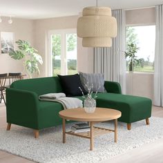 a living room with a green couch and coffee table