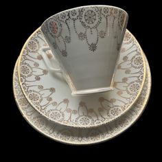 two white cups and saucers sitting on top of each other