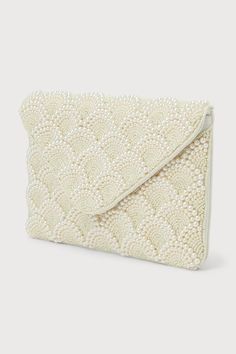 Special occasions deserve luxe accessories like the Lulus Glowing Aura Ivory Pearl Beaded Clutch! This stunning clutch boasts a scalloped design across the front, with beaded semi-circles accented by luminous faux pearls. An envelope-style flap has a magnetic closure that opens to reveal a spacious interior with a single sidewall pocket. Carry it as a chic clutch, or use the attachable silver chain to convert it to a convenient crossbody! Lined. Clutch Measures 10. 5" Wide, 7" Tall, And 0. 5" Deep (Relaxed). 45" Silver Chain Strap. Strap Has A 20. 5" Drop. 100% Cotton. Spot Clean Only. Imported. Lulus | Glowing Aura Ivory Pearl Beaded Clutch | 100% Cotton. Glowing Aura, Wedding Clutch Purse, Pearl Trend, Prom Clutch, Crochet Beach Bags, Pearl Clutch, Floral Clutches, White Clutch, Crochet Clutch