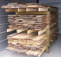 several stacks of wooden planks stacked on top of each other in a storage area