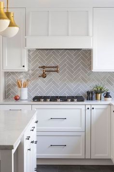 a kitchen with white cabinets and marble counter tops is featured on the instagram page