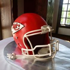 a cake shaped like a football helmet sitting on top of a table