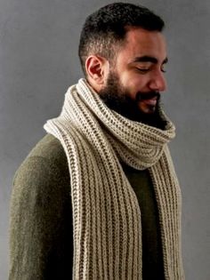 a man with a beard wearing a knitted scarf