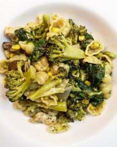 a white plate topped with pasta and broccoli