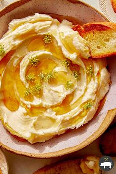 a bowl filled with hummus and bread on top of a table