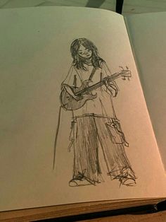 an open book with a drawing of a person holding a guitar