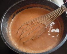 the whisk is being stirred in the sauce for the chocolate cake batter recipe