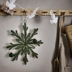 a christmas tree ornament hanging from a clothes line