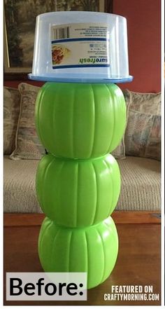 a stack of plastic pumpkins sitting on top of a wooden table next to a couch