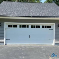 a white garage with two windows on the side