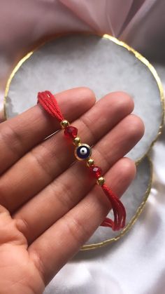 A Ghana or Mauli is a cultural thread tied on the wrist on an auspicious occasion to bring good luck.  It is commonly used at weddings during the Maiya, Vatna or Piti ceremonies.  The red thread used is made from 100% cotton thread. Evil eye used is gold plated. This listing is for 1 Thread or use the drop down to order a bundle of 10. Evil Eye Wedding, Red Thread, Beads Bracelet Design, Bracelet Design, Beads Bracelet, Cotton Thread