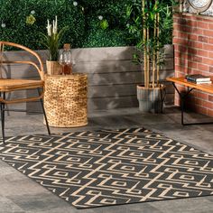 a black and white rug sitting on top of a floor next to a wooden bench