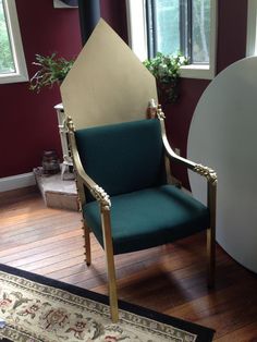 a green chair sitting on top of a hard wood floor next to a white rug