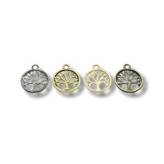 four charms with tree designs on them in gold, silver and bronze tone colors - set of 3