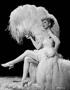 a woman sitting on top of a feather covered chair