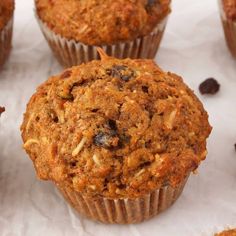 several muffins with raisins and chocolate chips on the side