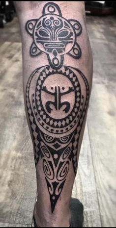 a man's leg with an ornamental tattoo design on the calf and lower leg