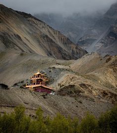 a building in the middle of some mountains