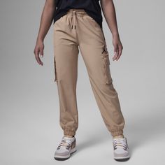 These pants, made of woven twill fabric, are just as much style as they are function. They have a jogger construction, the relaxed tapered legs and added stretch makes it comfy for freedom of movement, the elasticized waistband with drawcord provides helps you get a fit that's just right and with zippered and cargo pockets, you'll have plenty of space to stash small items. Nike Kids, Kids Pants, Cargo Trousers, Tapered Legs, Big Kids, Cargo Pants, Air Jordan, Jogging, Jordan