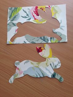 two pieces of paper cut out to look like animals