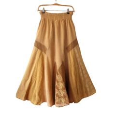 An easy-to-carry all season skirt in a beautiful mustard yellow that suits everyone.  The fabric has a soft touch feel and the skirt is heavy weight fabric for all seasons wear. It is with an elastic waistband.  A traditional occasion, a dinner date, a everyday use - this skirt will give you the confidence to look your best every time you wear it. Although, you can wear this skirt casually it looks really beautiful on special events and occasions. Designer - Tina Olsen, Made in Italy The skirt i Traditional Yellow Skirt For Summer, Yellow Bohemian Skirt For Summer, Yellow Long Skirt For Fall, Yellow Bohemian Ruffled Skirt Bottoms, Traditional Yellow Summer Skirt, Yellow Long Skirt For Festival, Beige Bohemian Flared Maxi Skirt, Bohemian Beige Flared Maxi Skirt, Bohemian Yellow Skirted Bottoms