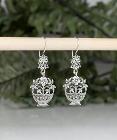 925 Sterling Silver Daisy Flower Basket Earrings Handmade Artisan Crafted Filigree Ornate Dangle Drop Earrings Material: 925 Sterling Silver Earrings Length: 2 inches Width: 0.75 inches Finishing: Oxidized and Polished Comes with a gift pouch and box Free Domestic Shipping Our fine silver jewelry is Made in our exclusive Artisan workshops in Turkey. Our aim is to exceed all the expectations that you have from silver jewelry. Filigree is the art of embroidery with metal thread. It dates back in T Traditional Silver Earrings With Ear Wire, Artisan Sterling Silver Wedding Earrings, Traditional Flower-shaped Earrings With Ear Wire, Traditional Silver Drop Flower Earrings, Traditional Sterling Silver Earrings In Flower Shape, Traditional Sterling Silver Flower-shaped Earrings, Traditional Silver Flower Earrings For Festive Occasions, Traditional Sterling Silver Flower Shaped Earrings, Traditional Pierced Flower Jewelry