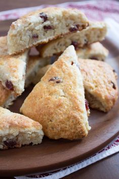 several scones on a plate with one cut in half and the other stacked up