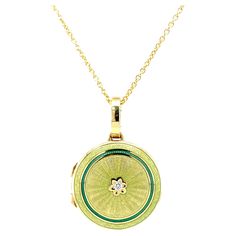 Victor Mayer round locket pendant necklace with flower 18k yellow gold, Hallmark Collection, translucent light green and dark green vitreous enamel, 1 diamond, total 0.03 ct, H VS, diameter app. 21.0 mm About the creator Victor Mayer Victor Mayer is internationally renowned for elegant timeless designs and unrivalled expertise in historic craftsmanship. Lovers of the extraordinary appreciate the beauty of Victor Mayer's designs, which use extremely rare techniques such as genuine enamel or elabo Yellow Gold Enamel Medallion Necklace, Oval Enamel Locket Jewelry, Yellow Gold Enamel Oval Jewelry, Oval Locket Necklace In Enamel, Oval Enamel Locket Necklace, Oval Yellow Gold Enamel Jewelry, Green Flower Pendant Fine Jewelry, Antique Green Locket Jewelry, Engraved Yellow Gold Necklace With Enamel