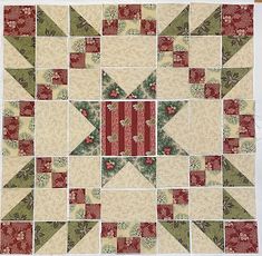 a quilted wall hanging with red, green and white squares on it's sides