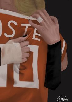 a person with their hands on the back of an orange jersey