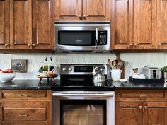 a kitchen with wooden cabinets and stainless steel appliances