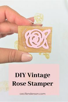 a hand holding a rubber stamp with the words diy vintage rose stamp on it