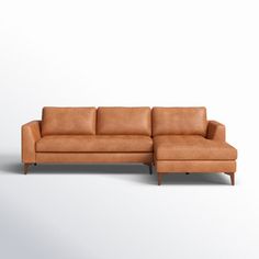 a brown leather sectional sofa sitting on top of a white floor next to a wooden frame