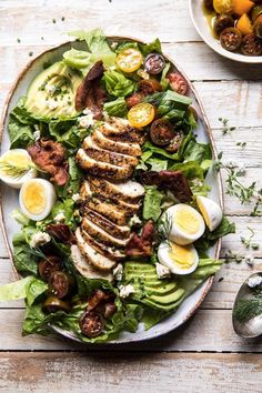 a salad with bacon, hard boiled eggs and lettuce