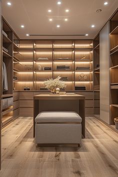 a walk - in closet with wooden shelves and drawers is lit by recessed lights